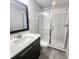 Modern bathroom with glass enclosed shower, stylish vanity, and tile flooring at 191 Aidans Lndg, Haines City, FL 33844