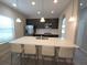 Modern eat-in kitchen featuring a large island with white countertops, stainless appliances, and pendant lighting at 191 Aidans Lndg, Haines City, FL 33844