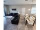 Open-concept living room and dining area with modern furniture and a sliding glass door for natural light at 191 Aidans Lndg, Haines City, FL 33844