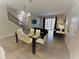 Open-concept living space with a dining table, staircase, and sliding glass doors to the outdoor area at 191 Aidans Lndg, Haines City, FL 33844