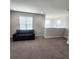 Cozy loft area featuring neutral carpet and a comfortable sofa, perfect for a relaxing space at 191 Aidans Lndg, Haines City, FL 33844