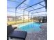 Screened-in backyard pool featuring a brick patio and comfortable seating at 191 Aidans Lndg, Haines City, FL 33844