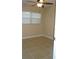 Bright bedroom featuring neutral paint, tile floors, and a ceiling fan at 2005 Kingsland Ave, Orlando, FL 32808