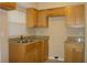 Well-lit kitchen featuring wood cabinets, granite countertops, and tile flooring at 2005 Kingsland Ave, Orlando, FL 32808