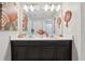 Well decorated bathroom with double sinks, dark wood cabinets, a large mirror, and colorful accents at 2151 Valencia Blossom St, Clermont, FL 34711