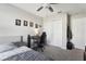 Bedroom with a bed, desk, fan, closet, and decorative wall art, creating a cozy atmosphere at 2151 Valencia Blossom St, Clermont, FL 34711