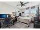 Spacious bedroom with a desk, ceiling fan, and large window, offering a comfortable and well-lit space at 2151 Valencia Blossom St, Clermont, FL 34711