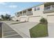 Exterior view of townhomes featuring private balconies, driveways, and individual one-car garages at 2151 Valencia Blossom St, Clermont, FL 34711