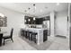 Modern kitchen with stainless steel appliances, a breakfast bar, and pendant lighting at 2151 Valencia Blossom St, Clermont, FL 34711
