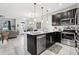 Modern kitchen featuring stainless steel appliances and sleek, black cabinetry at 2151 Valencia Blossom St, Clermont, FL 34711