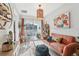 Cozy living area with decorative plants, a colorful rug, and a sliding glass door to the balcony at 2151 Valencia Blossom St, Clermont, FL 34711