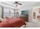 Relaxing main bedroom featuring a ceiling fan, lots of natural light, and comfortable furnishings at 2151 Valencia Blossom St, Clermont, FL 34711