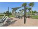 Community poolside area featuring lounge chairs, shady dining areas, and surrounding palm trees at 2151 Valencia Blossom St, Clermont, FL 34711