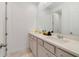 Bathroom featuring dual sinks, granite counters, and a large mirror at 2224 Celebration Blvd, Celebration, FL 34747