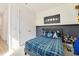 Bedroom with a plaid bedspread, and moon art piece on the wall at 2224 Celebration Blvd, Celebration, FL 34747
