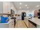 Bright kitchen with stainless steel appliances, center island, and light wood floors, perfect for Gathering gatherings at 2224 Celebration Blvd, Celebration, FL 34747