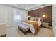 Comfortable primary bedroom with decorative wall, pendant lighting, and plush carpeting at 2224 Celebration Blvd, Celebration, FL 34747