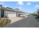 View of modern townhomes with two-car garages, lush landscaping, and street parking at 2224 Celebration Blvd, Celebration, FL 34747