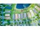 Aerial view of neighborhood homes around a pond with well-manicured lawns and trees at 233 Rialto Rd, Kissimmee, FL 34759