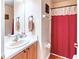 Bathroom featuring a red shower curtain, sink with vanity, and a mirror at 233 Rialto Rd, Kissimmee, FL 34759
