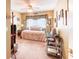 Cozy bedroom with neutral tones, carpet, and a window providing natural light at 233 Rialto Rd, Kissimmee, FL 34759