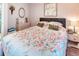 Inviting bedroom featuring plush floral bedding, decorative pillows, and comfortable furnishings at 233 Rialto Rd, Kissimmee, FL 34759