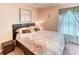 Inviting bedroom with plush floral bedding, a decorative headboard and warm lighting at 233 Rialto Rd, Kissimmee, FL 34759