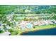 Community pool nestled among mature trees with tennis court, green landscaping and water views at 233 Rialto Rd, Kissimmee, FL 34759