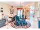 Cozy dining area features a glass table, chandelier, and access to other rooms of the house at 233 Rialto Rd, Kissimmee, FL 34759