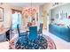Lovely dining area with glass table set, elegant chandelier, and natural lighting, perfect for Gathering meals at 233 Rialto Rd, Kissimmee, FL 34759