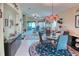Elegant dining room with modern chandelier, glass table, and views of the living area at 233 Rialto Rd, Kissimmee, FL 34759