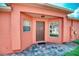 Inviting entrance with brick flooring, covered porch, and well-lit doorway at 233 Rialto Rd, Kissimmee, FL 34759