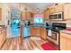 The kitchen features stainless steel appliances, wood cabinets and ample countertop space for cooking at 233 Rialto Rd, Kissimmee, FL 34759