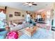 Comfortable living room features neutral tones, ceiling fan, and access to the dining area, perfect for relaxation at 233 Rialto Rd, Kissimmee, FL 34759