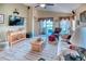 Spacious living room with entertainment center, vaulted ceilings, and sliding door at 233 Rialto Rd, Kissimmee, FL 34759