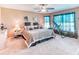 Relaxing bedroom with neutral colors, a ceiling fan, and two large windows, perfect for unwinding at 233 Rialto Rd, Kissimmee, FL 34759