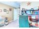 Office with a work desk, shelving, and a view into an adjoining room at 233 Rialto Rd, Kissimmee, FL 34759