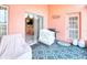 View of the patio with patterned floor, grill, covered seating, and sliding glass door to the interior at 233 Rialto Rd, Kissimmee, FL 34759