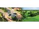 Aerial view of a golf course community with winding streets, lush green fairways, and meticulously maintained landscaping at 2333 Pinehurst Ct, Davenport, FL 33837