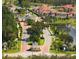 This aerial view captures an extensive community with homes surrounding a golf course and green spaces at 2333 Pinehurst Ct, Davenport, FL 33837