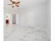 Spacious bedroom features marble flooring, modern ceiling fan, and neutral walls at 2333 Pinehurst Ct, Davenport, FL 33837