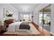 Bright bedroom with hardwood floors, a bay window, and a comfortable seating area at 2333 Pinehurst Ct, Davenport, FL 33837