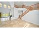 Grand foyer with a staircase and marble floors, leading to a formal living area at 2333 Pinehurst Ct, Davenport, FL 33837