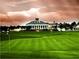View of the lush green golf course and grand clubhouse at Providence Golf Club, ideal for relaxation and recreation at 2333 Pinehurst Ct, Davenport, FL 33837