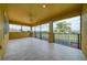 Spacious screened lanai with scenic views of the lush landscaping and pond at 2333 Pinehurst Ct, Davenport, FL 33837