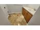 Small laundry area with a sink, wooden cabinets, and neutral countertops at 2333 Pinehurst Ct, Davenport, FL 33837