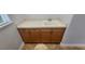 Laundry room with a sink, wooden cabinets, and neutral countertops at 2333 Pinehurst Ct, Davenport, FL 33837