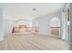 Open living space with wood floors and ample natural light from large windows at 2333 Pinehurst Ct, Davenport, FL 33837
