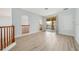 Bright living room with wood flooring and a large sliding glass door to the balcony at 2333 Pinehurst Ct, Davenport, FL 33837