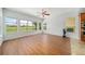 Spacious living area with wood-style tile flooring and plenty of natural light from large windows at 2333 Pinehurst Ct, Davenport, FL 33837